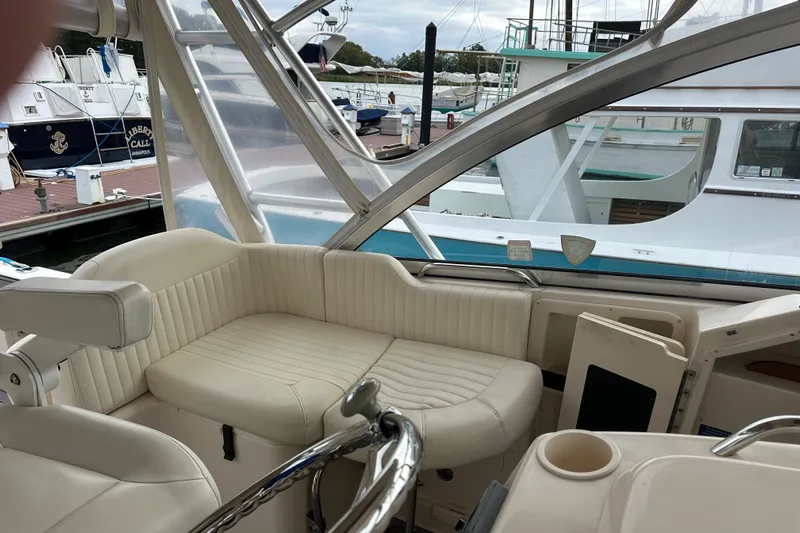 Triple Threat Yacht Photos Pics 2008 Grady-White Express 330 boat interior with cream seating at marina.