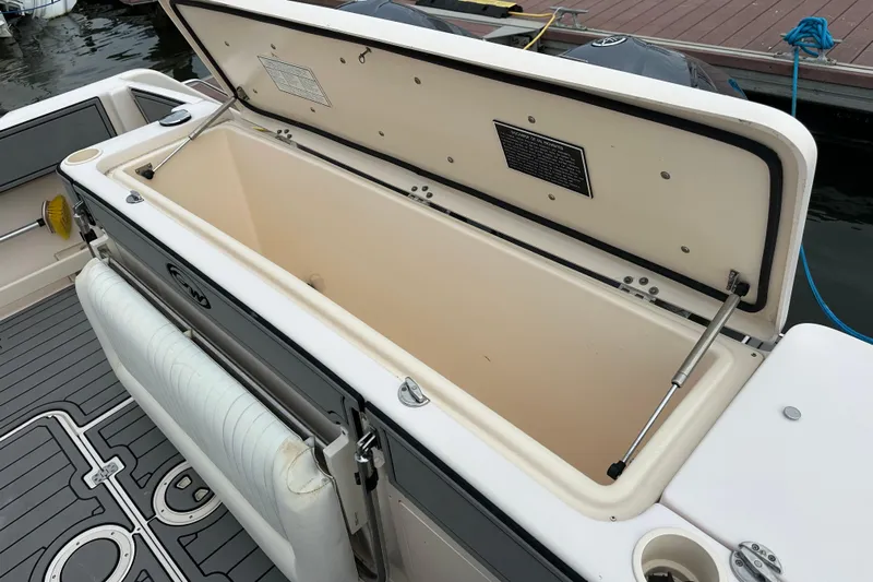 Triple Threat Yacht Photos Pics 2008 Grady-White Express 330 boat with open storage compartment on deck.