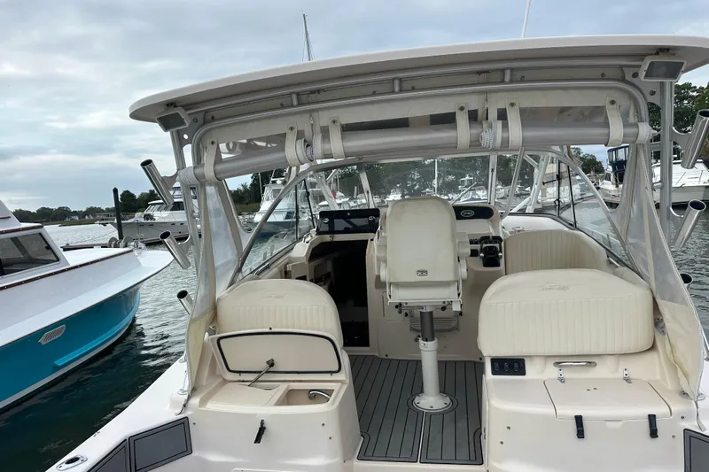 Triple Threat Yacht Photos Pics 2008 Grady-White Express 330 boat interior at marina, featuring helm and seating area.