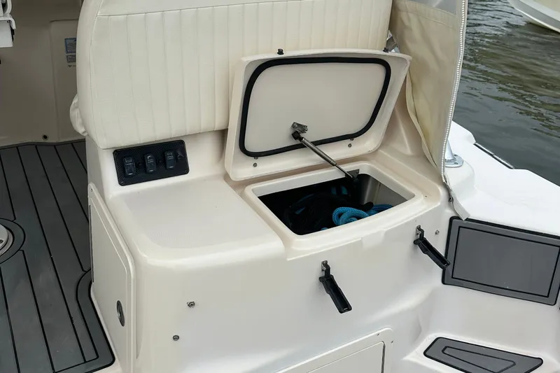 Triple Threat Yacht Photos Pics 2008 Grady-White Express 330 boat storage compartment with open hatch and visible ropes.