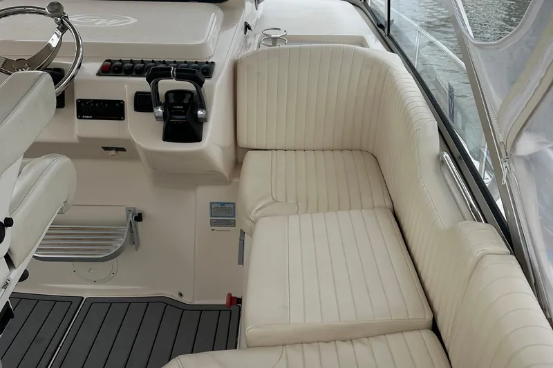 Triple Threat Yacht Photos Pics 2008 Grady-White Express 330 boat interior with white seating and control panel.