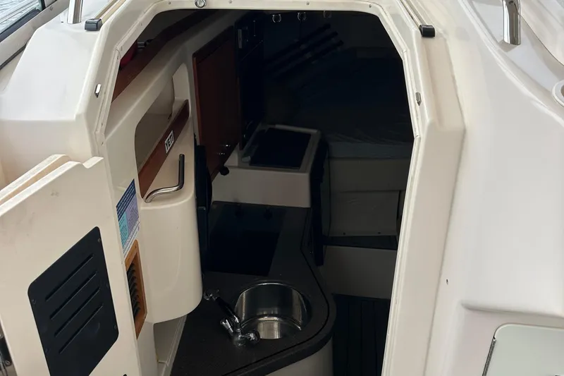 Triple Threat Yacht Photos Pics 2008 Grady-White Express 330 cabin interior with sink and compact layout.