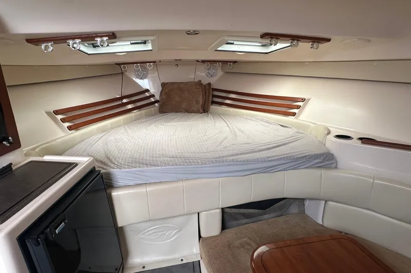 Triple Threat Yacht Photos Pics 2008 Grady-White Express 330 cabin interior with bed, skylights, and seating area.