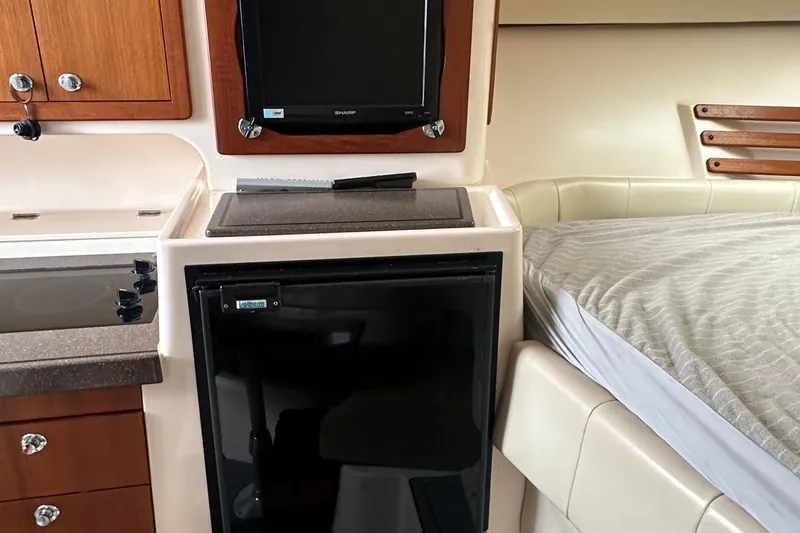 Triple Threat Yacht Photos Pics 2008 Grady-White Express 330 cabin interior with kitchenette and bed.