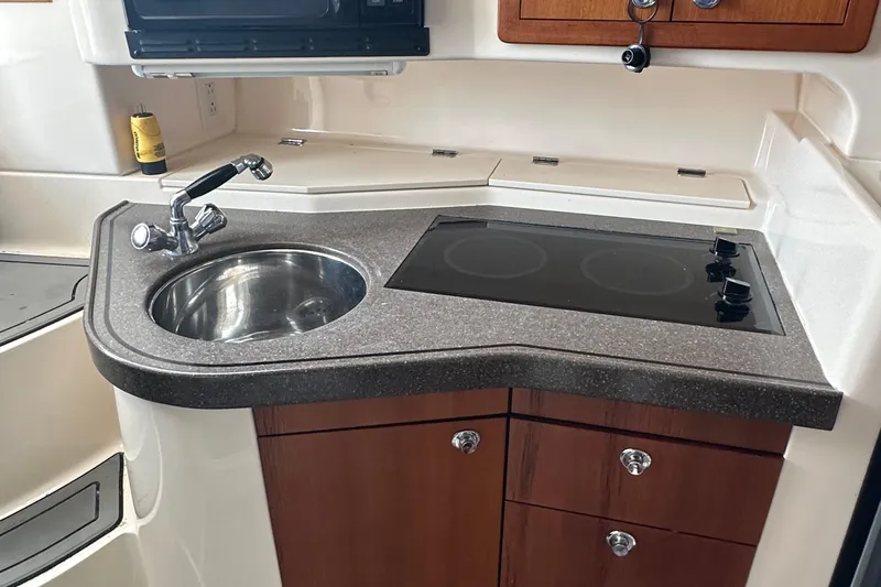 Triple Threat Yacht Photos Pics 2008 Grady-White Express 330 boat kitchen with sink and stovetop.