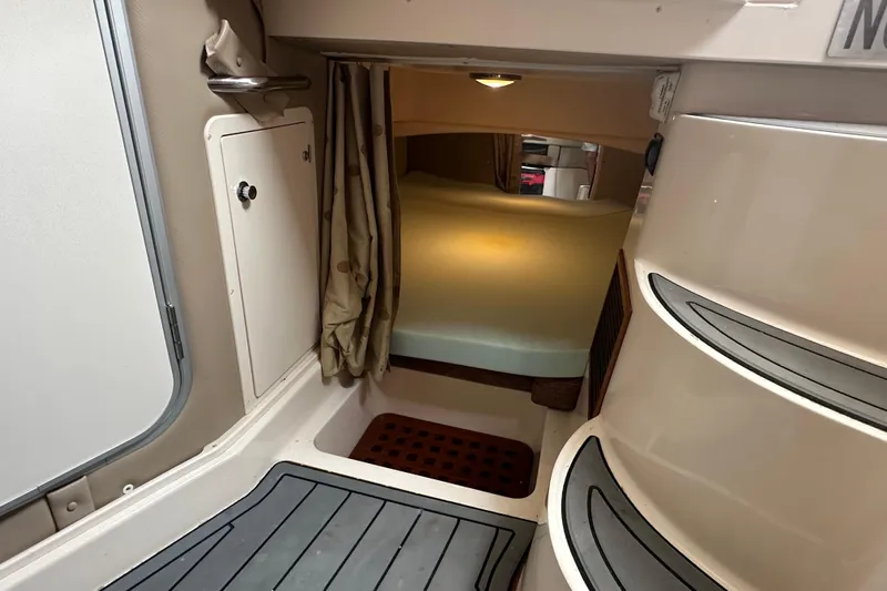 Triple Threat Yacht Photos Pics 2008 Grady-White Express 330 cabin interior with steps and storage area.