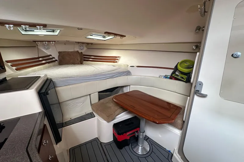 Triple Threat Yacht Photos Pics 2008 Grady-White Express 330 cabin interior with bed, table, and storage.