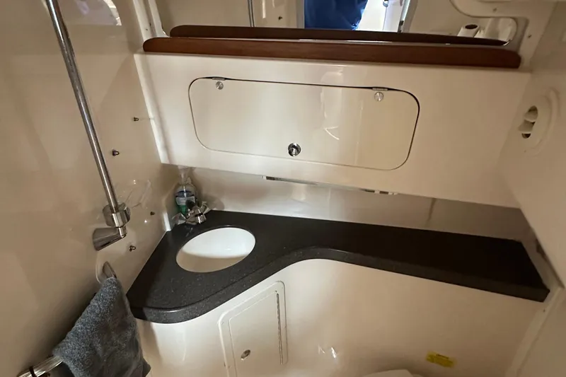 Triple Threat Yacht Photos Pics 2008 Grady-White Express 330 boat bathroom with sink and storage cabinet.