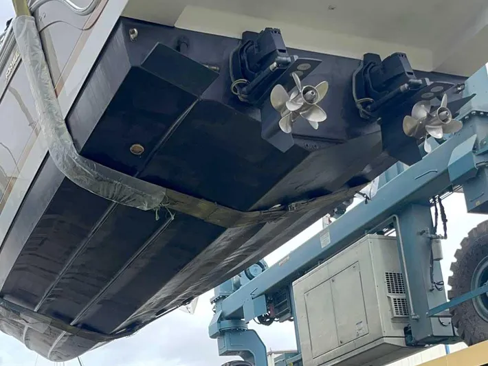  Yacht Photos Pics 2003 Formula 37 PC boat on lift, showing dual propellers and hull.