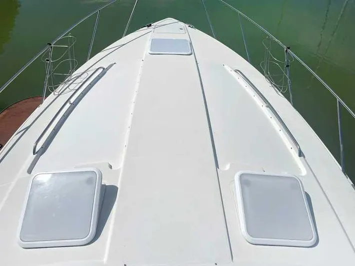  Yacht Photos Pics 2003 Formula 37 PC yacht deck with hatches and railings on calm water.