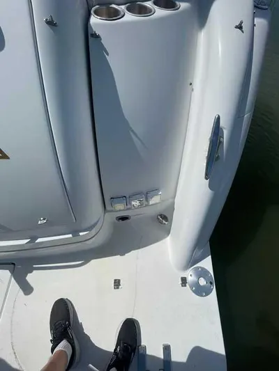  Yacht Photos Pics 2003 Formula 37 PC boat deck with cup holders and person wearing black shoes.