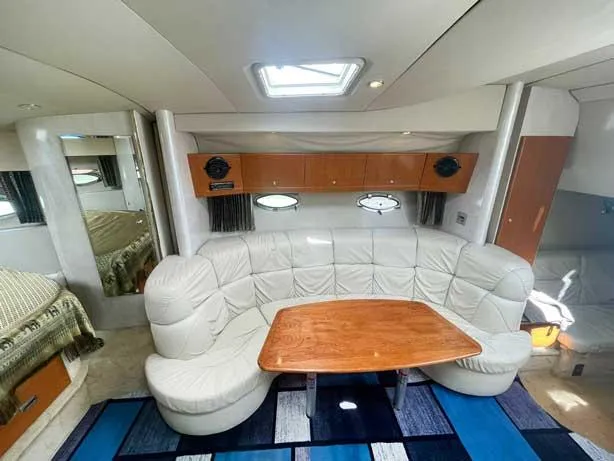  Yacht Photos Pics Interior of 2003 Formula 37 PC yacht with white leather seating and wooden table.