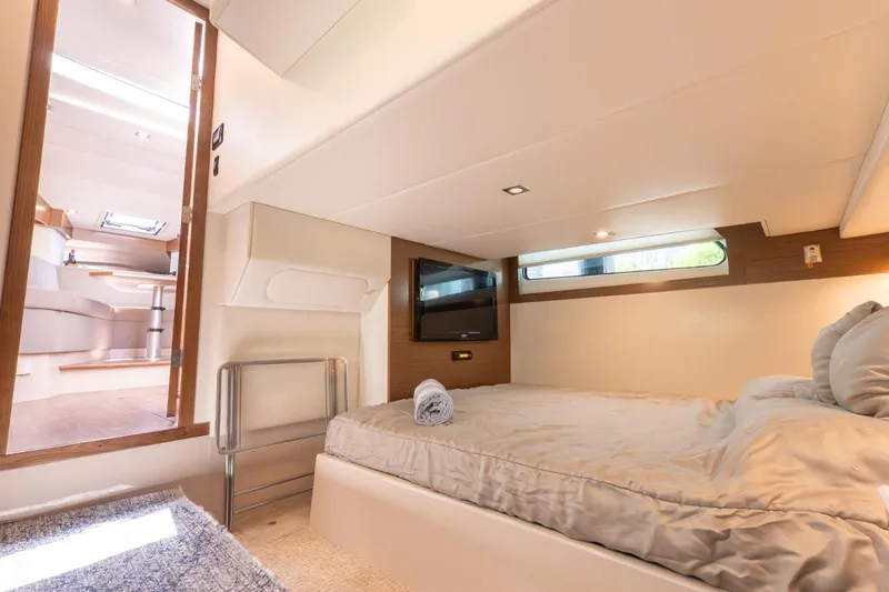  Yacht Photos Pics Luxurious cabin interior of 2016 Cruisers Yachts 390 Express Coupe, featuring a cozy bed and modern decor.