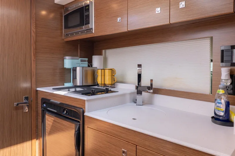  Yacht Photos Pics Modern kitchen in 2016 Cruisers Yachts 390 Express Coupe with sleek appliances and wood cabinetry.