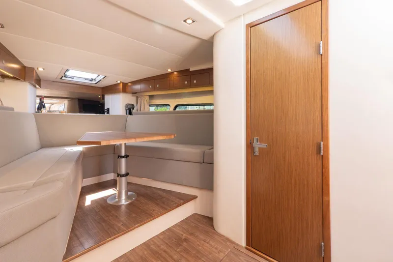  Yacht Photos Pics 2016 Cruisers Yachts 390 Express Coupe interior with modern seating and wooden accents.