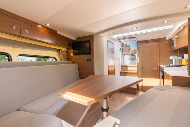  Yacht Photos Pics Interior of 2016 Cruisers Yachts 390 Express Coupe, featuring modern seating and dining area.