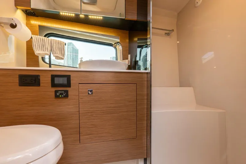  Yacht Photos Pics Luxurious bathroom interior of 2016 Cruisers Yachts 390 Express Coupe with modern fixtures.