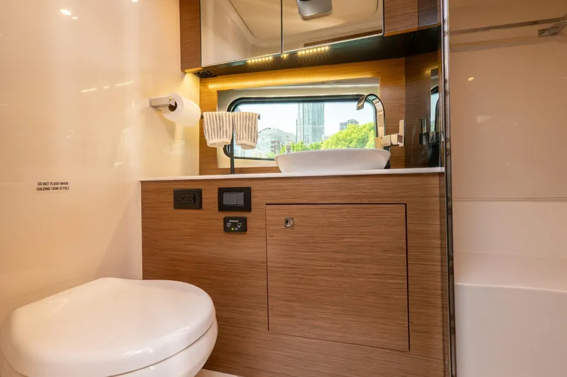  Yacht Photos Pics Luxurious bathroom in 2016 Cruisers Yachts 390 Express Coupe with modern fixtures and wood accents.