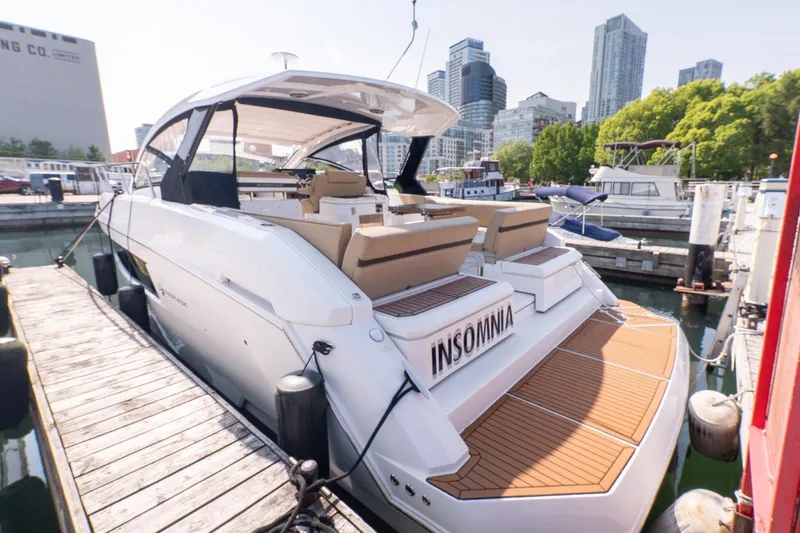  Yacht Photos Pics 2016 Cruisers Yachts 390 Express Coupe docked in urban marina setting.