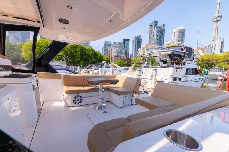  Yacht Photos Pics 2016 Cruisers Yachts 390 Express Coupe with city skyline and marina backdrop.