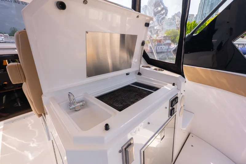  Yacht Photos Pics Outdoor kitchen on 2016 Cruisers Yachts 390 Express Coupe with grill and sink.