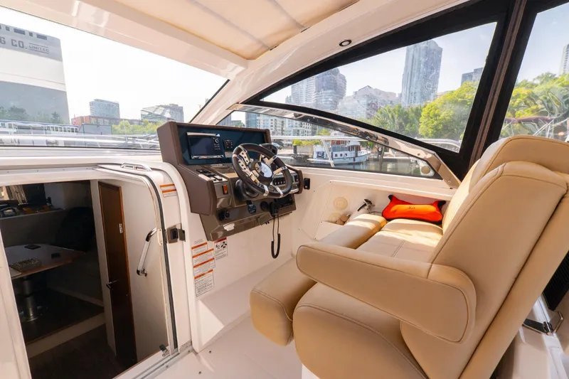  Yacht Photos Pics 2016 Cruisers Yachts 390 Express Coupe interior with helm, cityscape view.