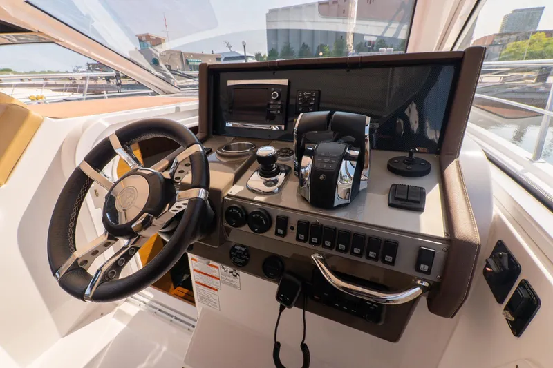  Yacht Photos Pics 2016 Cruisers Yachts 390 Express Coupe helm with modern controls and steering wheel.
