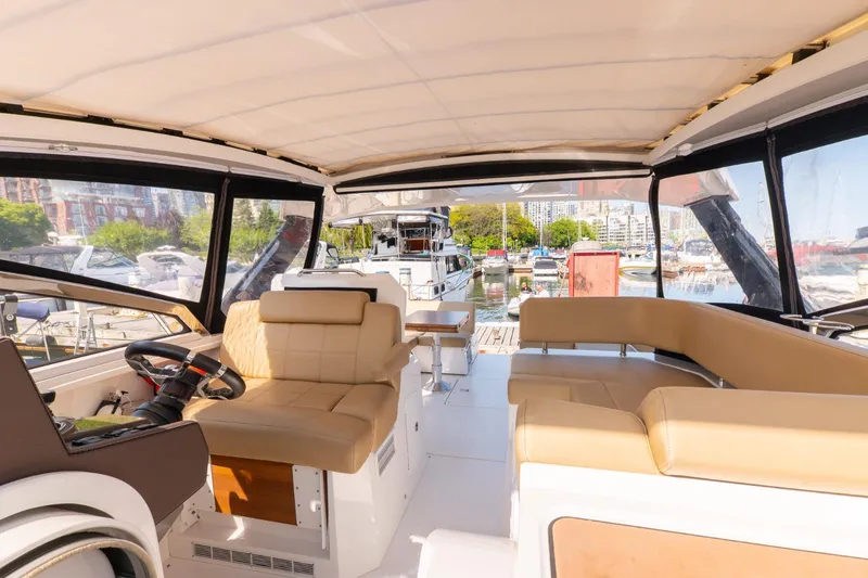  Yacht Photos Pics Interior of 2016 Cruisers Yachts 390 Express Coupe with beige seating and marina view.