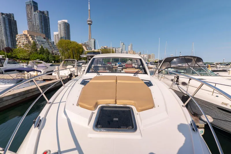  Yacht Photos Pics 2016 Cruisers Yachts 390 Express Coupe docked in urban marina with city skyline.