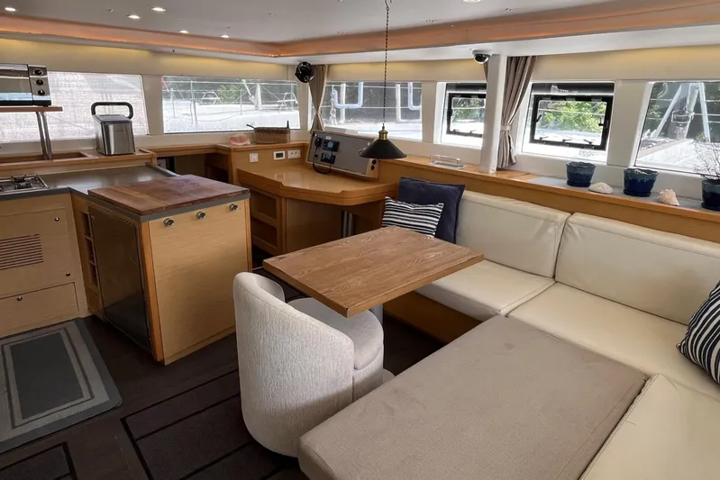  Yacht Photos Pics Interior of 2018 Lagoon 450 catamaran with modern kitchen and cozy seating area.