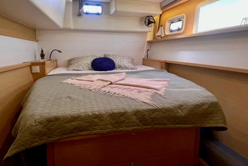  Yacht Photos Pics Cozy bedroom interior of 2018 Lagoon 450 yacht with bed and decorative pillows.