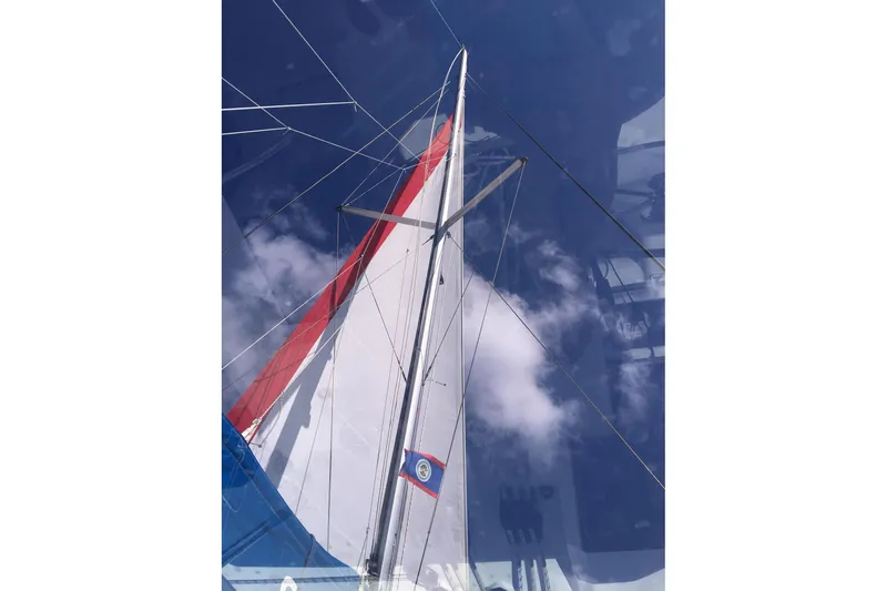 Nice Aft Too Yacht Photos Pics Sailboat mast and sails against a clear blue sky, Leopard 45, 2018 model.