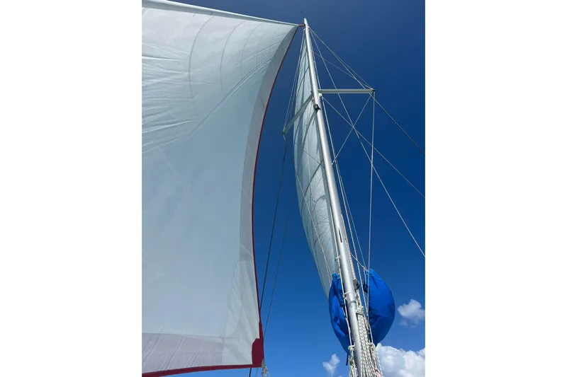 Nice Aft Too Yacht Photos Pics Sail of a 2018 Leopard 45 catamaran against a clear blue sky.