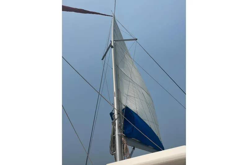 Nice Aft Too Yacht Photos Pics Sail of a 2018 Leopard 45 catamaran against a clear blue sky.