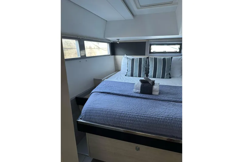 Nice Aft Too Yacht Photos Pics Luxurious bedroom interior of 2018 Leopard 45 yacht with striped pillows and blue bedding.
