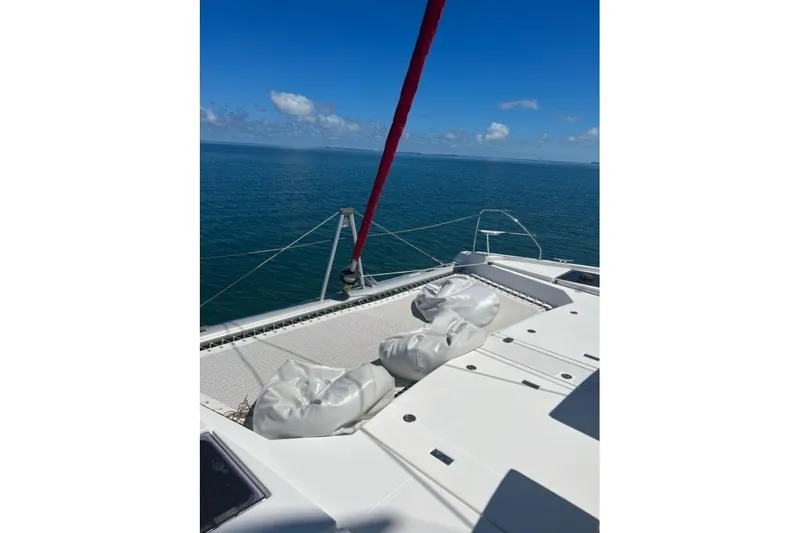 Nice Aft Too Yacht Photos Pics Catamaran deck view on a 2018 Leopard 45, sailing in clear blue waters.