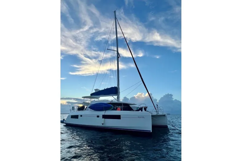 Nice Aft Too Yacht Photos Pics 2018 Leopard 45 catamaran sailing on calm ocean at sunset.