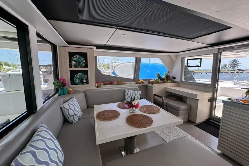 Nice Aft Too Yacht Photos Pics Luxurious interior of 2018 Leopard 45 catamaran with dining area and scenic views.