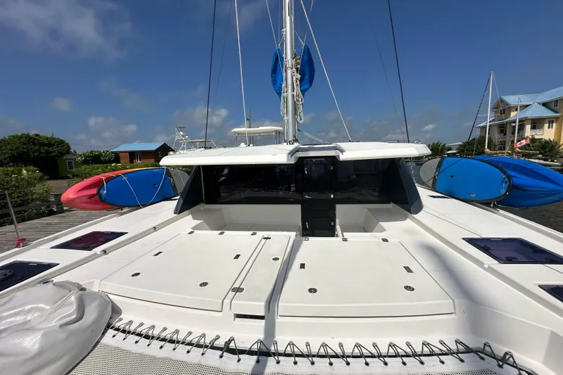 Nice Aft Too Yacht Photos Pics 2018 Leopard 45 catamaran with kayaks, docked under clear blue skies.