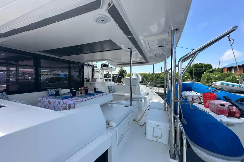 Nice Aft Too Yacht Photos Pics Spacious deck of a 2018 Leopard 45 catamaran with outdoor seating and dining area.
