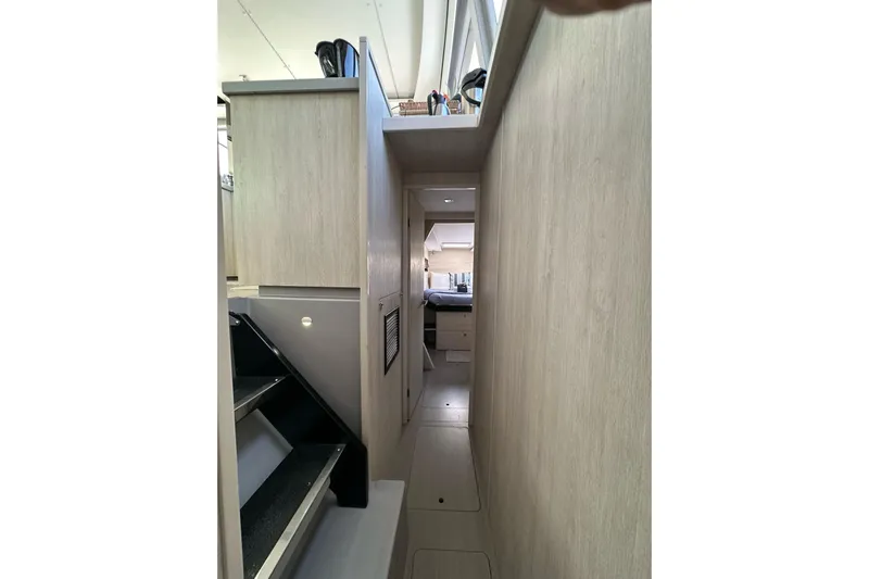 Nice Aft Too Yacht Photos Pics Narrow hallway inside 2018 Leopard 45 yacht, featuring modern interior design and staircase.
