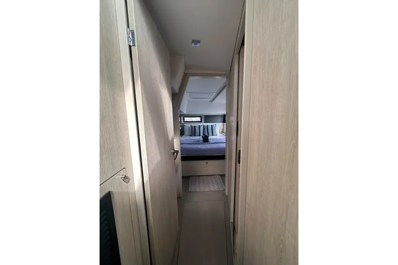 Nice Aft Too Yacht Photos Pics Narrow hallway leading to a cozy bedroom in a 2018 Leopard 45 yacht.