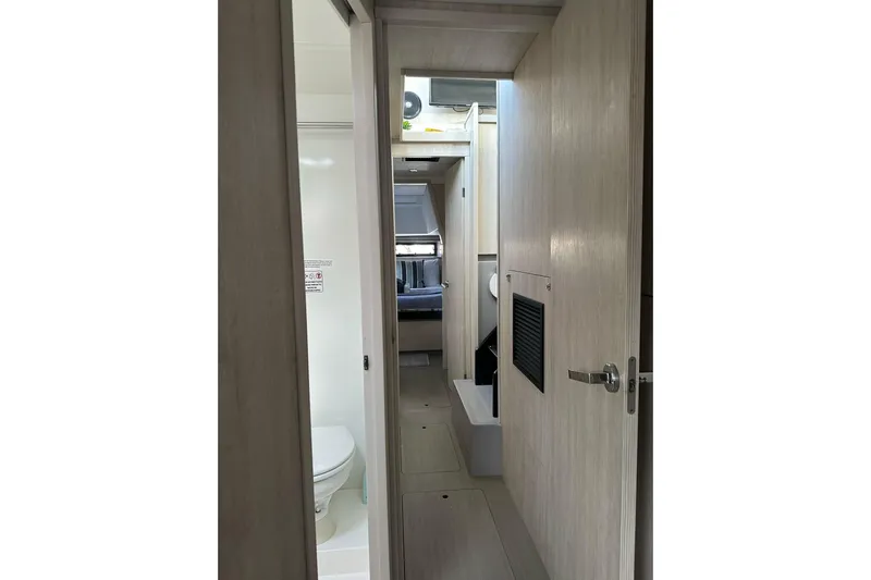 Nice Aft Too Yacht Photos Pics Interior view of 2018 Leopard 45 yacht, featuring hallway and bathroom.