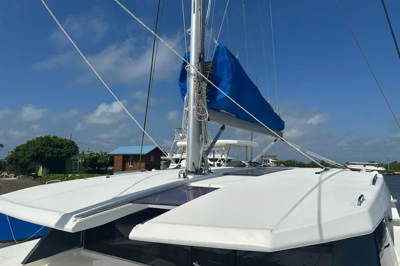 Nice Aft Too Yacht Photos Pics 2018 Leopard 45 catamaran with blue sail cover, docked under clear skies.