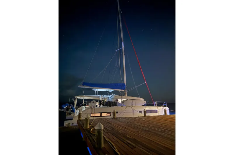 Nice Aft Too Yacht Photos Pics Leopard 45 catamaran docked at night, 2018 model, with illuminated deck and sails.