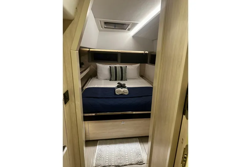 Nice Aft Too Yacht Photos Pics Cozy cabin interior of 2018 Leopard 45 yacht with neatly arranged bed and towels.