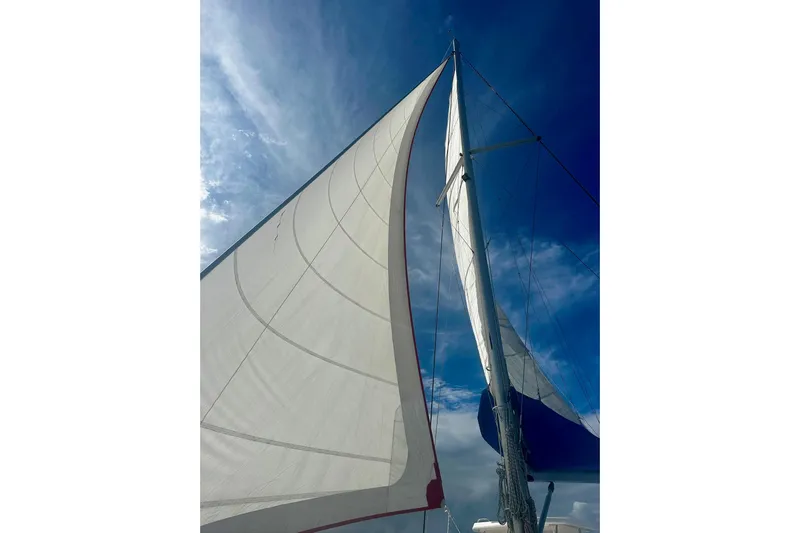 Nice Aft Too Yacht Photos Pics Sailing yacht Leopard 45 (2018) with sails unfurled against a clear blue sky.