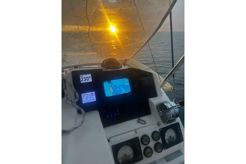 Nice Aft Too Yacht Photos Pics Cockpit view of 2018 Leopard 45 yacht at sunset, featuring navigation instruments.