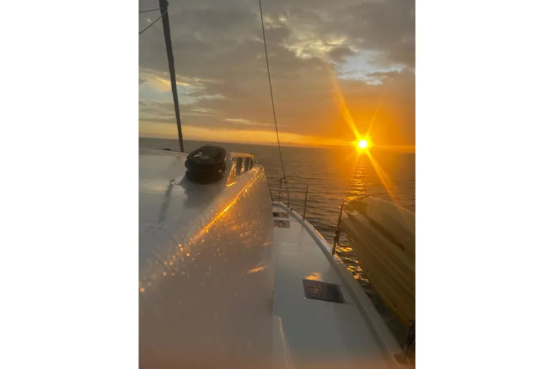 Nice Aft Too Yacht Photos Pics Sailing on a 2018 Leopard 45 catamaran at sunset, ocean horizon view.