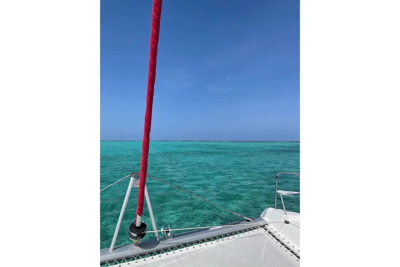 Nice Aft Too Yacht Photos Pics Sailing on a 2018 Leopard 45 catamaran over clear turquoise waters under a blue sky.